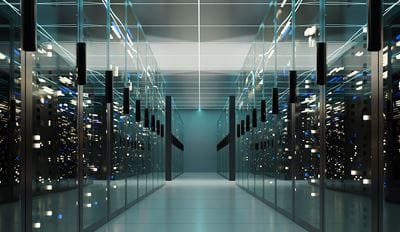 A spacious data center hallway filled with rows of servers