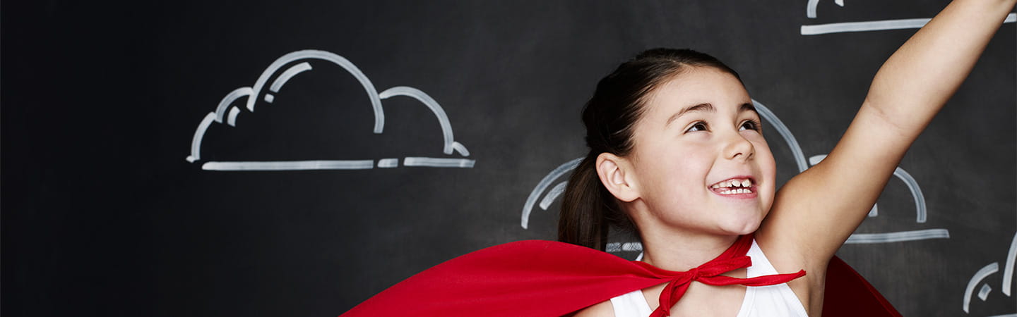 Young girl with superhero cape