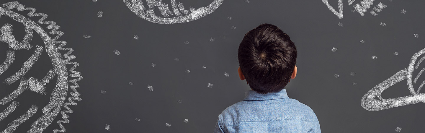 Young child looking at chalkboard