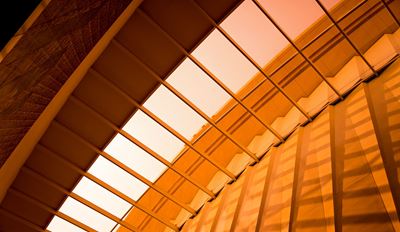 Modern orange glass ceiling with geometric skylight