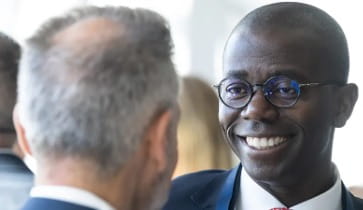 Seun Salami speaking to clients at an event