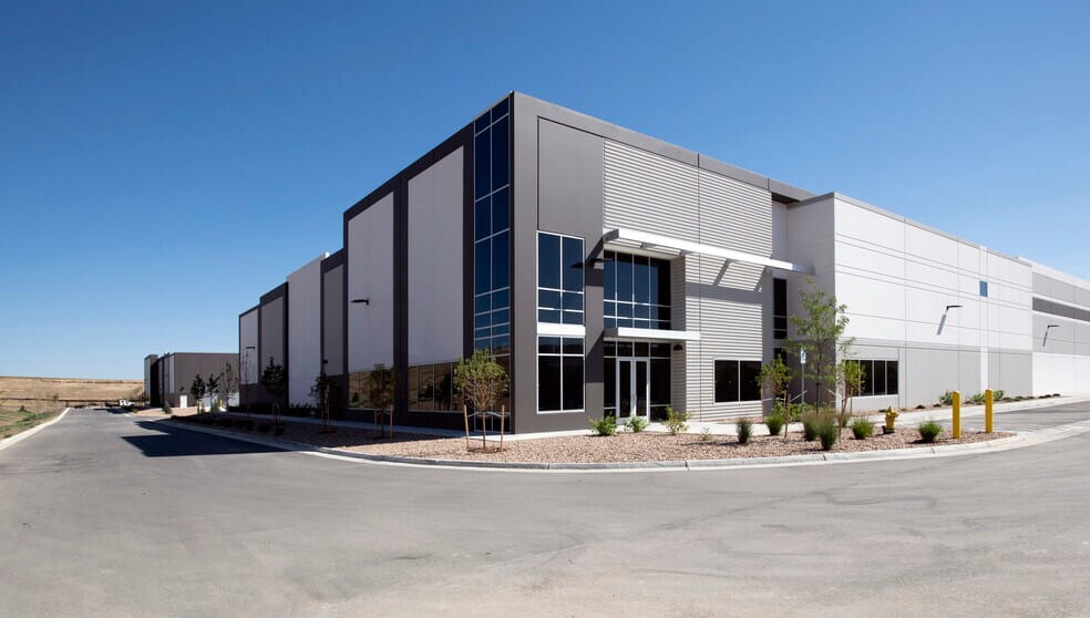 Exterior of Verve Commerce Center, a modern industrial warehouse with gray paneling and glass entry.