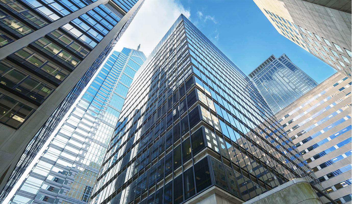 A skyline view featuring tall buildings against a clear blue sky in an urban setting.
