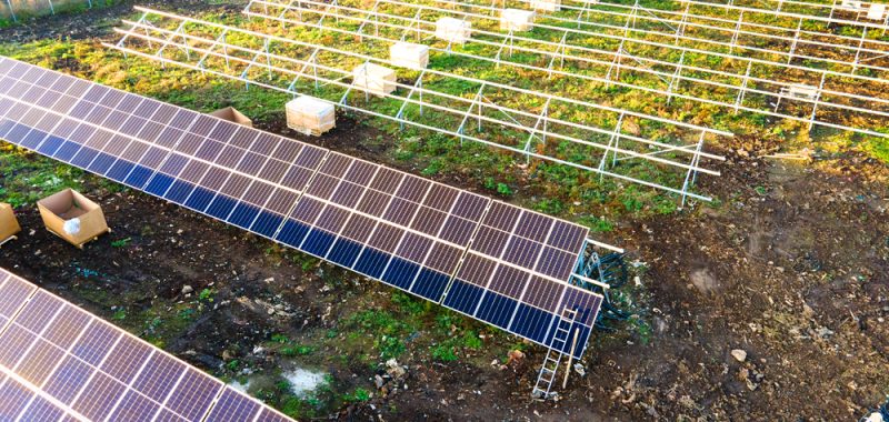 Solar panels under construction in field