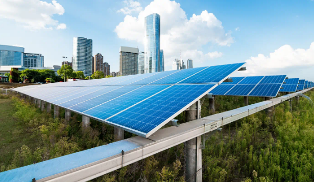 Solar panels on elevated structures overlook a city skyline